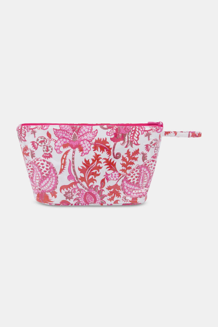 The Amanda Toiletry Case by Roller Rabbit is a rectangular bag with a zipper and small handle, featuring a pink and red floral and paisley print on white—ideal for organizing your travel essentials.