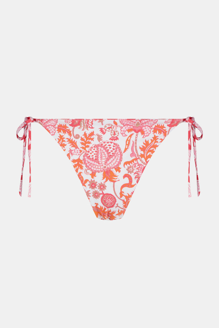 A person wears the Roller Rabbit Amanda/Jemina Serena Bikini Bottom, featuring UPF 50+ protection, white heart-shaped patterns, and side tie strings, shown from waist to mid-thigh against a plain background.
