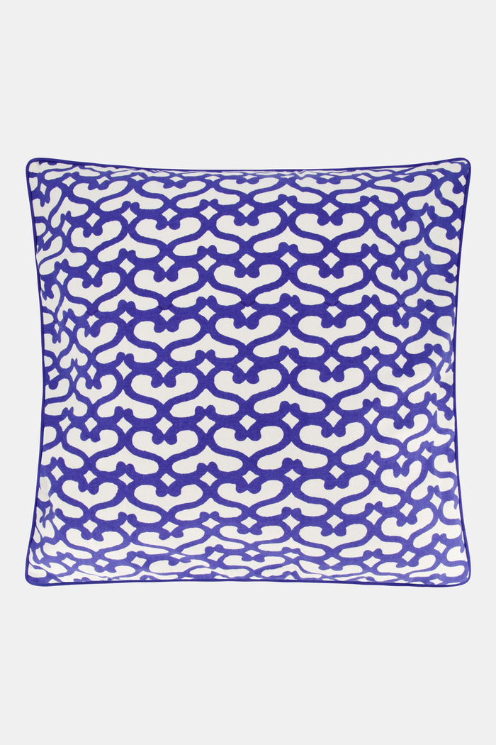The Big Cata Decorative Pillow by Roller Rabbit features a bold geometric deep blue and white pattern with interlocking shapes, matching blue piped edge, 100 cotton cover, and a plain light-colored background.