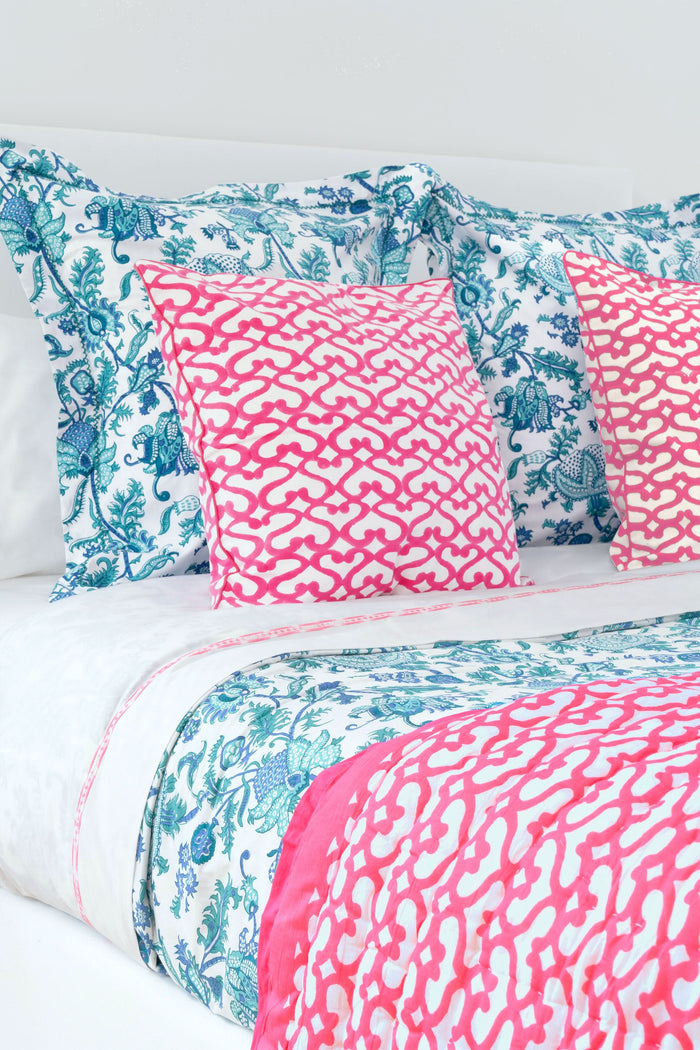 The Big Cata Decorative Pillow by Roller Rabbit features a white background with a bold pink geometric chain-link pattern. Made from 100 cotton with piped edges, it adds vibrant, modern style to any space.