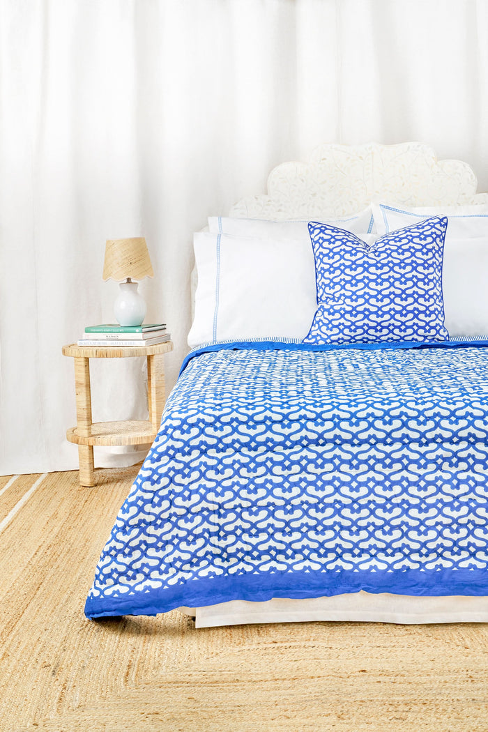 The Big Cata Decorative Pillow by Roller Rabbit features a bold geometric deep blue and white pattern with interlocking shapes, matching blue piped edge, 100 cotton cover, and a plain light-colored background.