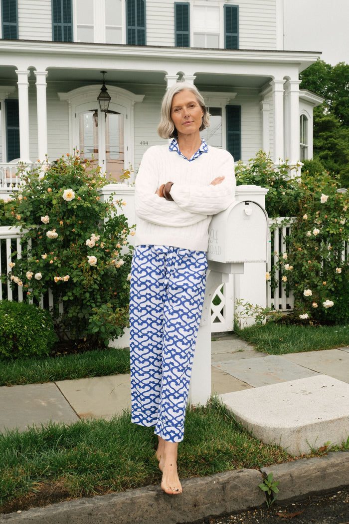 A woman stands barefoot in the Roller Rabbit Big Cata Liza Set, a matching short-sleeve pajama set made from cambric cotton with a blue and white Big Cata print, posing against a plain white background.