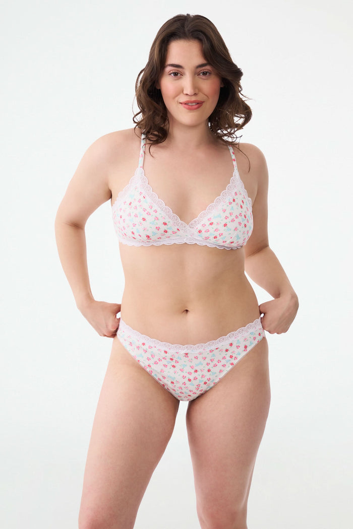 A person models the Roller Rabbit Bouquet Pointelle Waverly Bikini, a matching lace underwear set with a floral pattern, showing their torso and upper legs against a plain background.