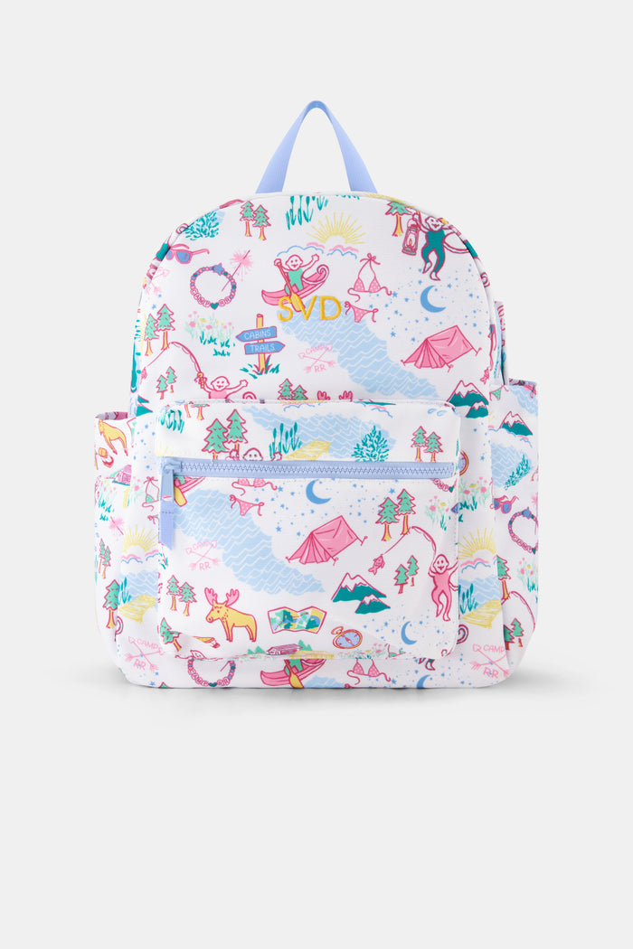 The Camp RR Backpack by Roller Rabbit features colorful cartoon camping scenes—mountains, animals, tents, trees, and rivers—plus playful characters in pink, blue, yellow, and green.