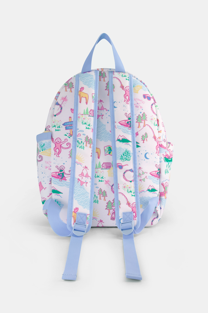 The Camp RR Backpack by Roller Rabbit features colorful cartoon camping scenes—mountains, animals, tents, trees, and rivers—plus playful characters in pink, blue, yellow, and green.