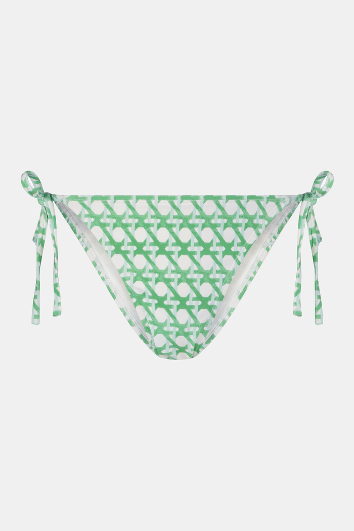 A person wearing the Roller Rabbit Cane Serena Bikini Bottom, a green and white patterned style with adjustable side ties, is shown from waist to upper thigh against a plain background.