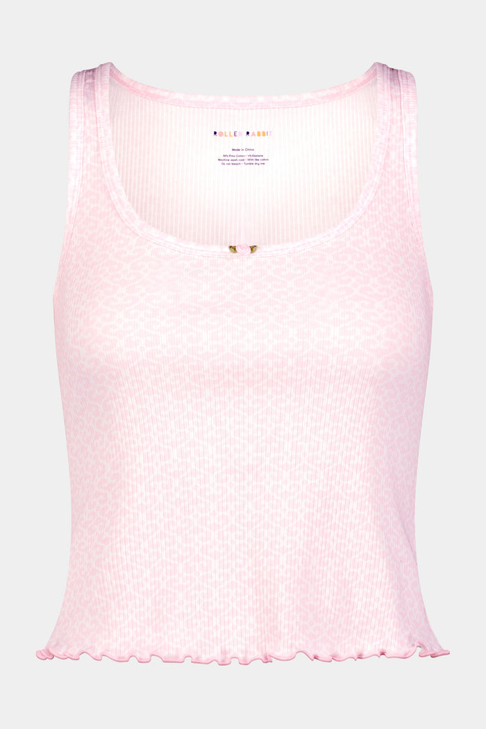 A woman wears the Roller Rabbit Catalina Rib Astor Tank in light pink with a small neckline bow and matching high-waisted button shorts. Against a plain background, her curly hair frames her face as she models these chic party PJs.