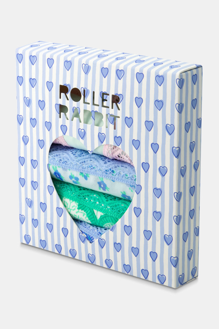 The Roller Rabbit Classic Core Thong 4 Pack features four pairs of lace-trim women’s underwear in pastel shades—pink with hearts, blue with flowers, printed blue, and green—offering soft cotton comfort and cute style.