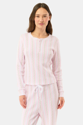 A woman wears the Roller Rabbit Daisy Heart Stripe Rosemary Top with pink, green, and white stripes, featuring a long-sleeved henley design, against a plain light background.