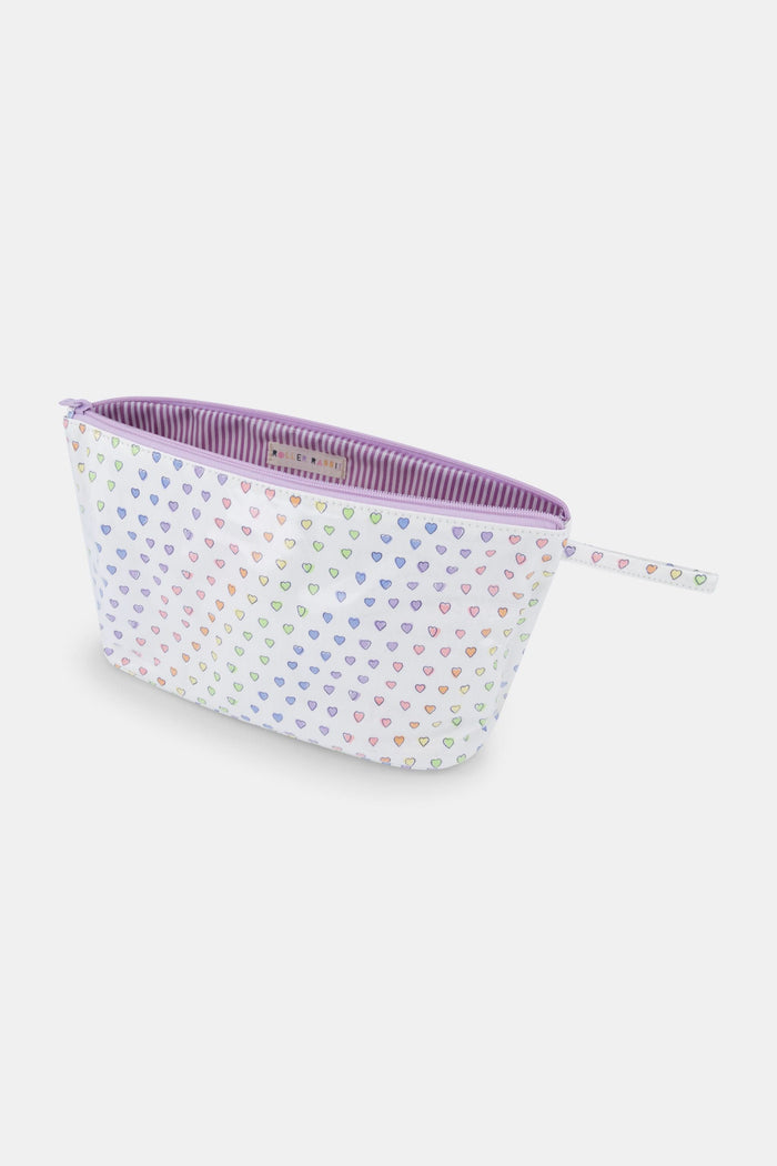 The Roller Rabbit Disco Hearts Toiletry Case is a white, rectangular zippered pouch with a strap, featuring a colorful heart pattern. Water-resistant and great for organizing your travel essentials.