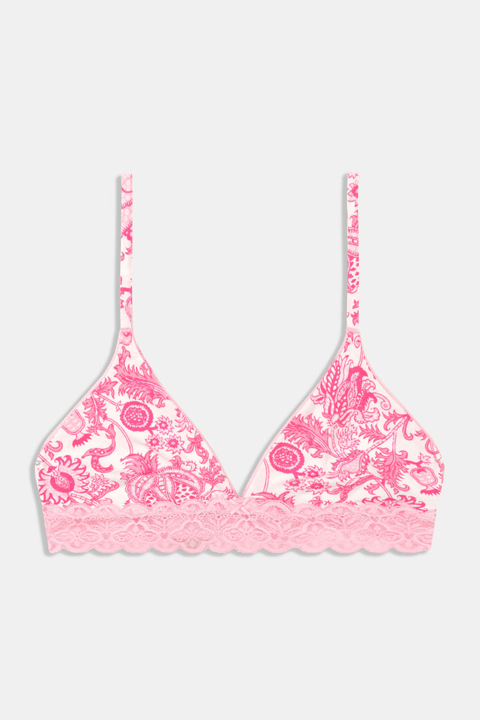 A woman with medium-length dark hair models the Ditsy Amanda Mercer Bralette by Roller Rabbit, featuring lace trim and a floral pattern, standing against a plain light background.
