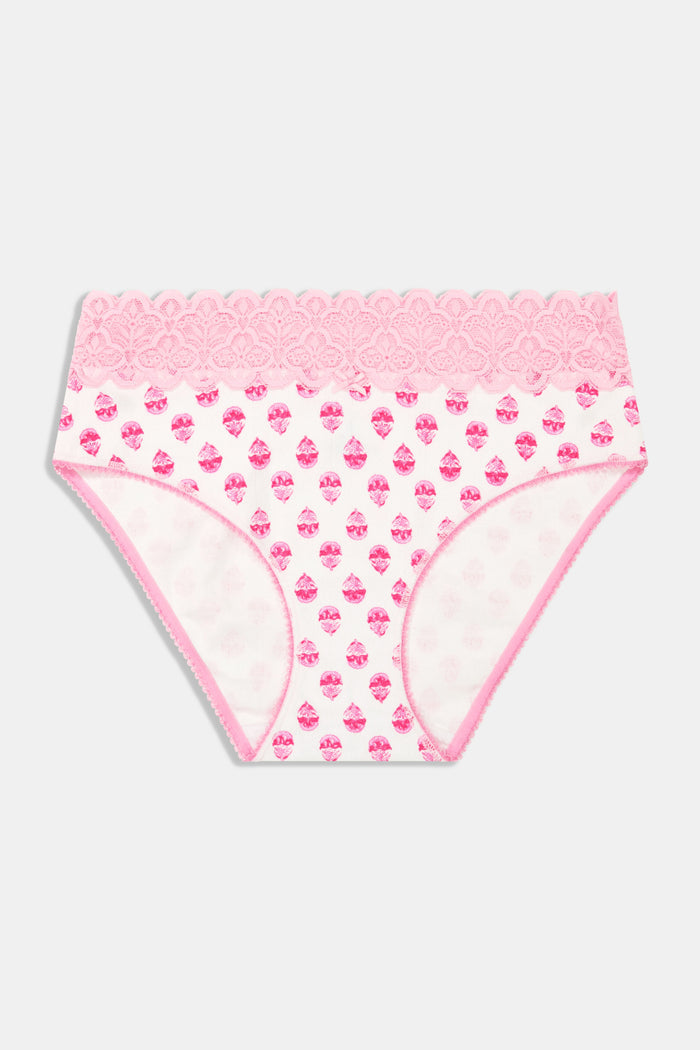 A woman poses sideways in a matching light pink Roller Rabbit Ditsy Daisy Pointelle Cornelia Hipster bra and high-waisted panties with small floral patterns and lace trim, against a plain white background.