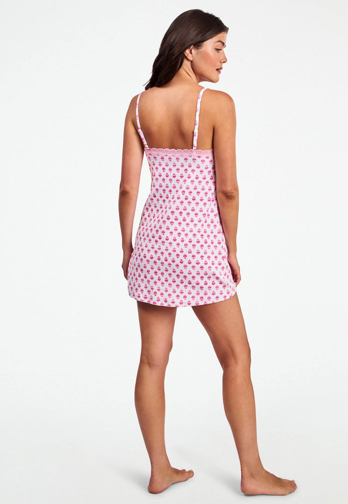 A woman wearing the Roller Rabbit Ditsy Daisy Pointelle Pearl Slip Dress with thin straps and a daisy pattern poses against a plain light background.