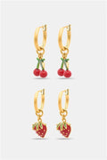The Roller Rabbit Fruits D'Eete Hoop Earring Pack features two gold huggie pairs: one with cherry charms, the other with strawberry charms. Mix and match for a playful summer accessory combo.