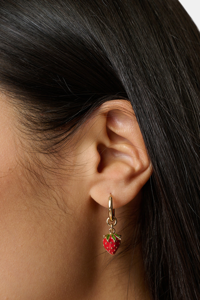 The Roller Rabbit Fruits D'Eete Hoop Earring Pack features two gold huggie pairs: one with cherry charms, the other with strawberry charms. Mix and match for a playful summer accessory combo.