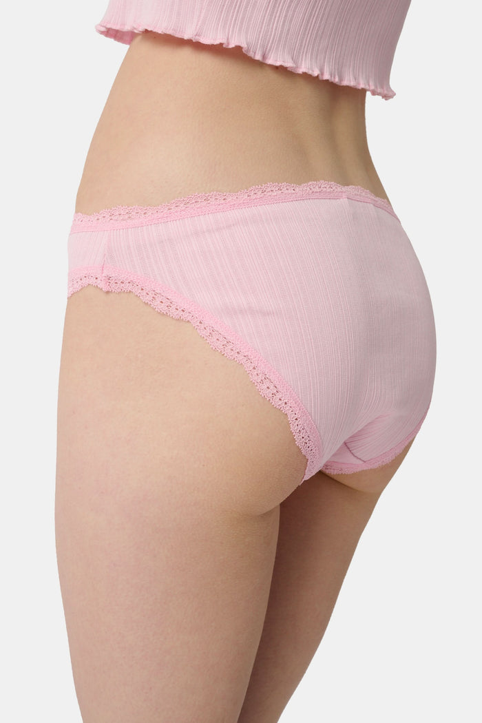 The Roller Rabbit Fruits Embroidery Bikini 4 Pack features four ribbed girls' panties—two pink, two light blue—made from soft Pima cotton with delicate lace trim and playful embroidered fruits for a retro touch.