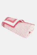 The Roller Rabbit Hearts Baby Quilt features a white cotton background with small red hearts print and a red and white border adorned with geometric and floral designs.