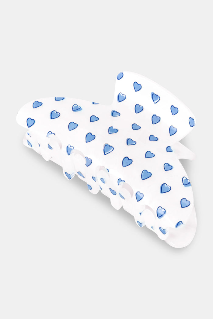 The Roller Rabbit Hearts Claw Clip, a blue classic claw-style hair clip adorned with small heart patterns, is displayed on a plain light gray background.