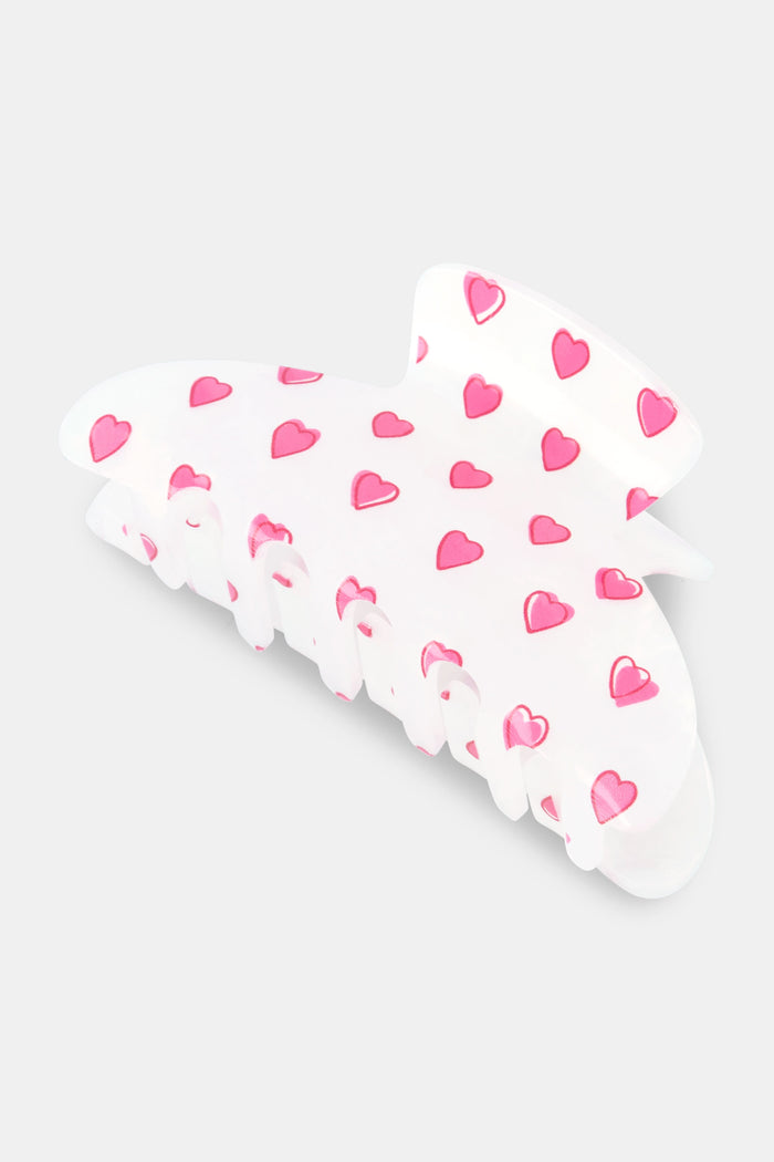 The Roller Rabbit Hearts Claw Clip is a white claw clip decorated with small pink hearts, shown on a plain light gray background.