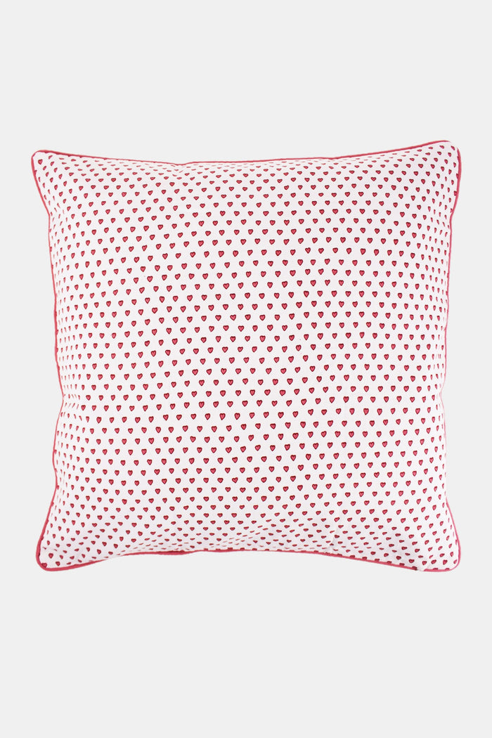 The Roller Rabbit Hearts Decorative Pillow is a rectangular white pillow with an evenly spaced pink heart print and red piping, crafted from 100 cotton for comfort and softness.