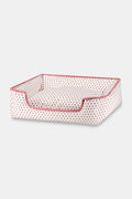 The Roller Rabbit Hearts Dog Bed is a rectangular, washable bed with a low front opening, white fabric adorned with red hearts, and red piping. It combines comfort and style for your pet.