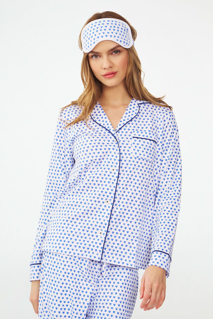 The Roller Rabbit Hearts Eye Mask, crafted from soft Pima Cotton with blue heart prints and an elastic strap, makes a cozy loungewear gift.
