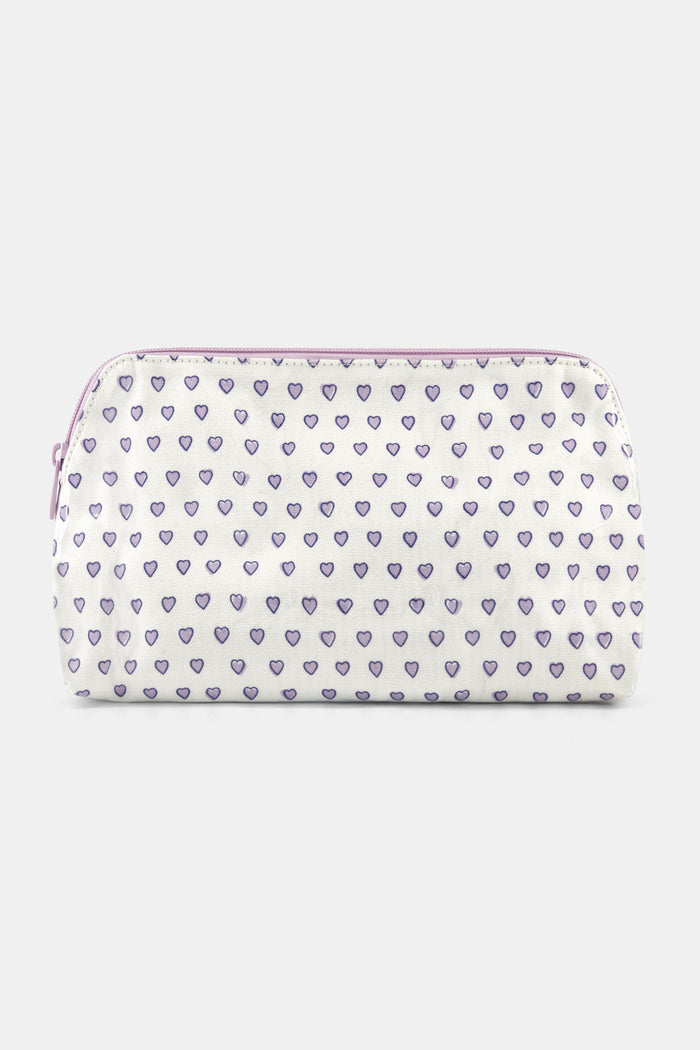 The Roller Rabbit Hearts Makeup Bag is a water-resistant canvas pouch with a white base, light purple zipper, and an allover print of small purple-outlined hearts.