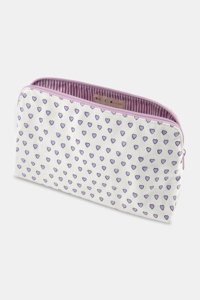 The Roller Rabbit Hearts Makeup Bag is a water-resistant canvas pouch with a white base, light purple zipper, and an allover print of small purple-outlined hearts.