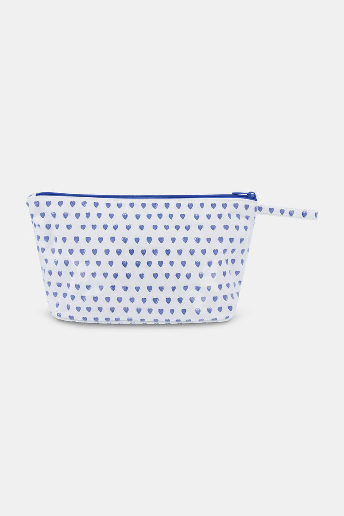 The Roller Rabbit Hearts Toiletry Case is a water-resistant white pouch featuring blue heart prints and a matching blue zipper pull, ideal for travel essentials, shown against a light gray background.
