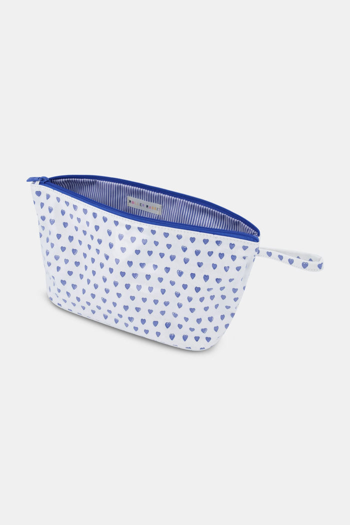 The Roller Rabbit Hearts Toiletry Case is a water-resistant white pouch featuring blue heart prints and a matching blue zipper pull, ideal for travel essentials, shown against a light gray background.