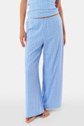 A person models the Roller Rabbit Hearts Vine Monroe Pant—loose-fitting, light blue pajama bottoms with a subtle vertical pattern. The image highlights only the lower body and the comfort of the cotton pointelle fabric.