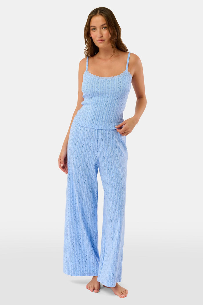A person models the Roller Rabbit Hearts Vine Monroe Pant—loose-fitting, light blue pajama bottoms with a subtle vertical pattern. The image highlights only the lower body and the comfort of the cotton pointelle fabric.