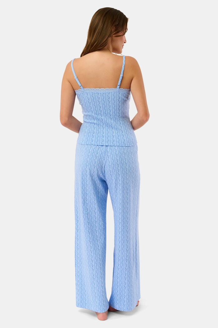 A person models the Roller Rabbit Hearts Vine Monroe Pant—loose-fitting, light blue pajama bottoms with a subtle vertical pattern. The image highlights only the lower body and the comfort of the cotton pointelle fabric.