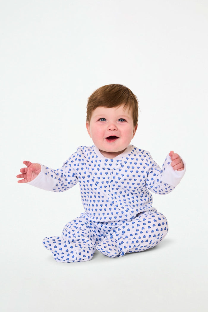 The Roller Rabbit Infant Hearts Zipper Footie is a white 100 cotton baby pajama with long sleeves, covered feet, and an all-over small blue hearts print, featuring a front zipper for easy dressing.
