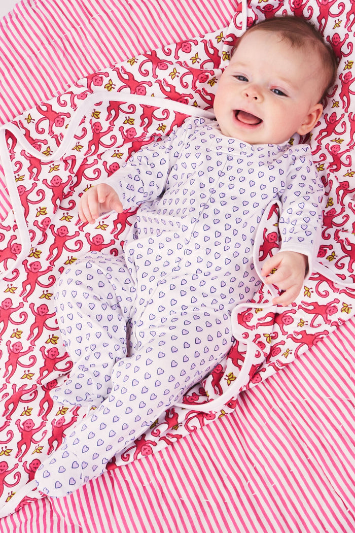 The Roller Rabbit Infant Hearts Zipper Footie is a white, 100 Pima cotton baby sleeper with long sleeves, footed legs, an all-over purple heart pattern, and a front zipper for easy changes.