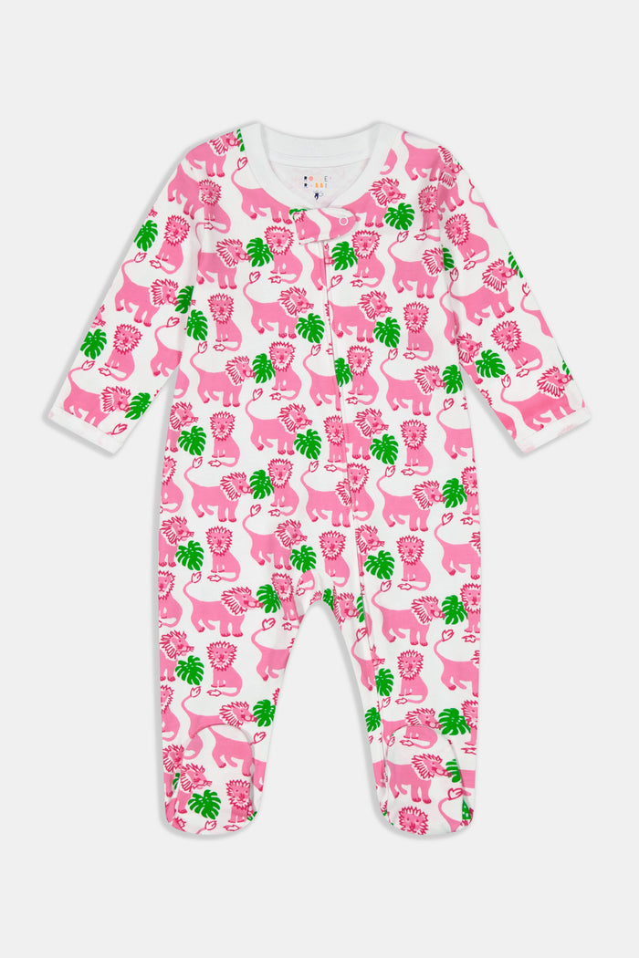 A smiling baby with light skin and short hair sits on a blue and white striped blanket wearing the Roller Rabbit Infant Leo The Lion Zipper Footie, made from soft Pima cotton with a convenient two-way zipper for easy dressing.