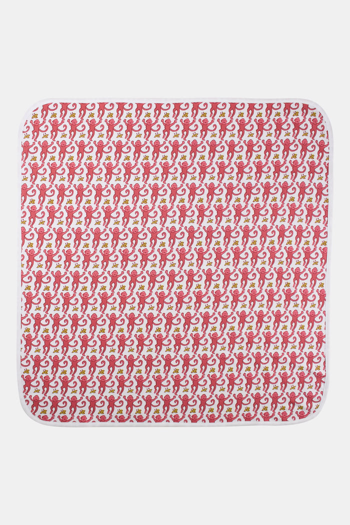 The Roller Rabbit Infant Monkey Receiving Blanket, made in Peru from Pima cotton, features a playful pink monkey and yellow banana print, and is shown folded to highlight both sides.