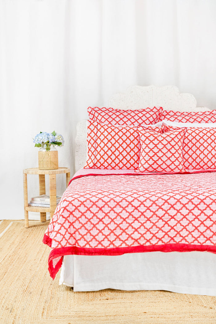 The Jemina Decorative Pillow by Roller Rabbit features a red and white scallop pattern with floral accents, red piping, and is crafted from 100 cotton on a plain white background.