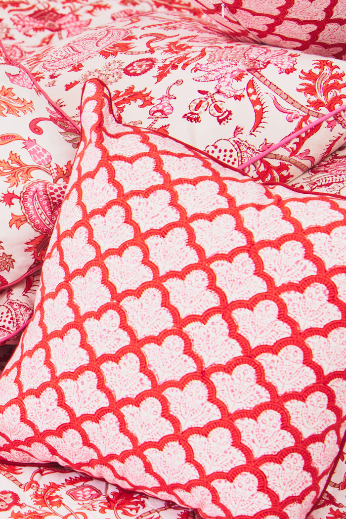 The Jemina Decorative Pillow by Roller Rabbit features a red and white scallop pattern with floral accents, red piping, and is crafted from 100 cotton on a plain white background.