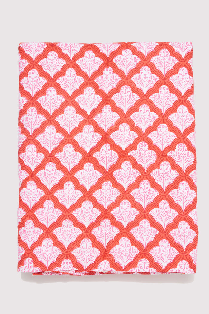 The Jemina Duvet Cover by Roller Rabbit features a red and white heart-patterned print, paired with matching pillow shams and crisp white sheets. Neatly arranged pillows and an ornate white headboard complete the airy, inviting bedding look.