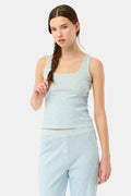 A young woman with long brown hair in a side braid models the Jemina Hearts Pointelle Astor Tank by Roller Rabbit, a pastel blue top, against a plain white background.