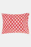 Two stacked Roller Rabbit Jemina Pillowcase Set pillowcases in a red and white print rest on a matching 100 cotton bedsheet, set against a white decorative background.