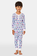 A young child stands smiling, wearing the Roller Rabbit Kids Austin Monkey Pajamas—a super soft pajama set with colorful, long sleeves and a playful cartoon monkey pattern on a white background.