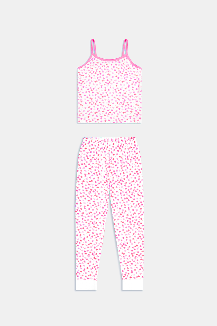 A young girl with long brown hair wears the Roller Rabbit Kids Bouquet Campbell Set, a pink and white pajama set with a floral print. She stands barefoot, smiling, against a plain light background with one foot slightly raised.