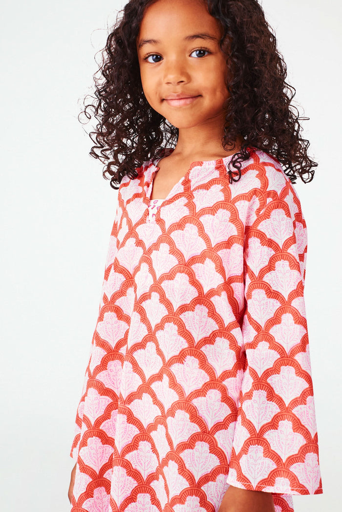 A young girl with curly hair smiles, wearing the Roller Rabbit Kids Jemina Kurta and beige espadrille sandals, standing against a plain white background.