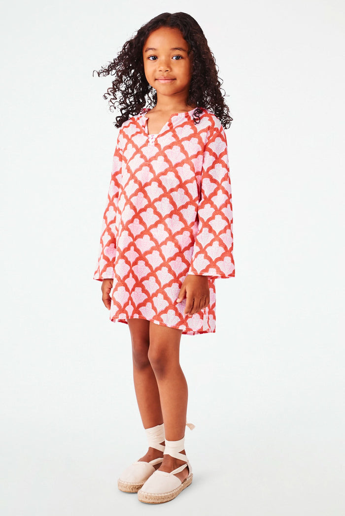 A young girl with curly hair smiles, wearing the Roller Rabbit Kids Jemina Kurta and beige espadrille sandals, standing against a plain white background.