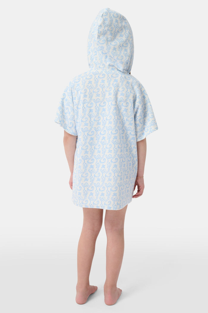 A young child smiles at the camera while wearing the Roller Rabbit Kids Monkey Jesse Cover Up, a white terry zip-up onesie with light blue animal prints and a hood.