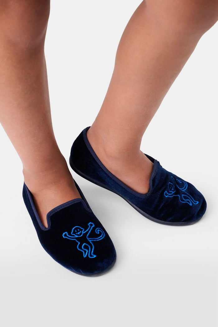 A pair of Kids Monkey Verona Slippers by Roller Rabbit, featuring embroidered monkeys, light tan lining, and black soles, is displayed on a plain white background.