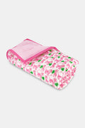 The Roller Rabbit Leo the Lion Baby Quilt features a soft cotton design with a pink border, white background, and playful pattern of pink elephants and green palm trees. A striped pink lining is visible along the folded edge.