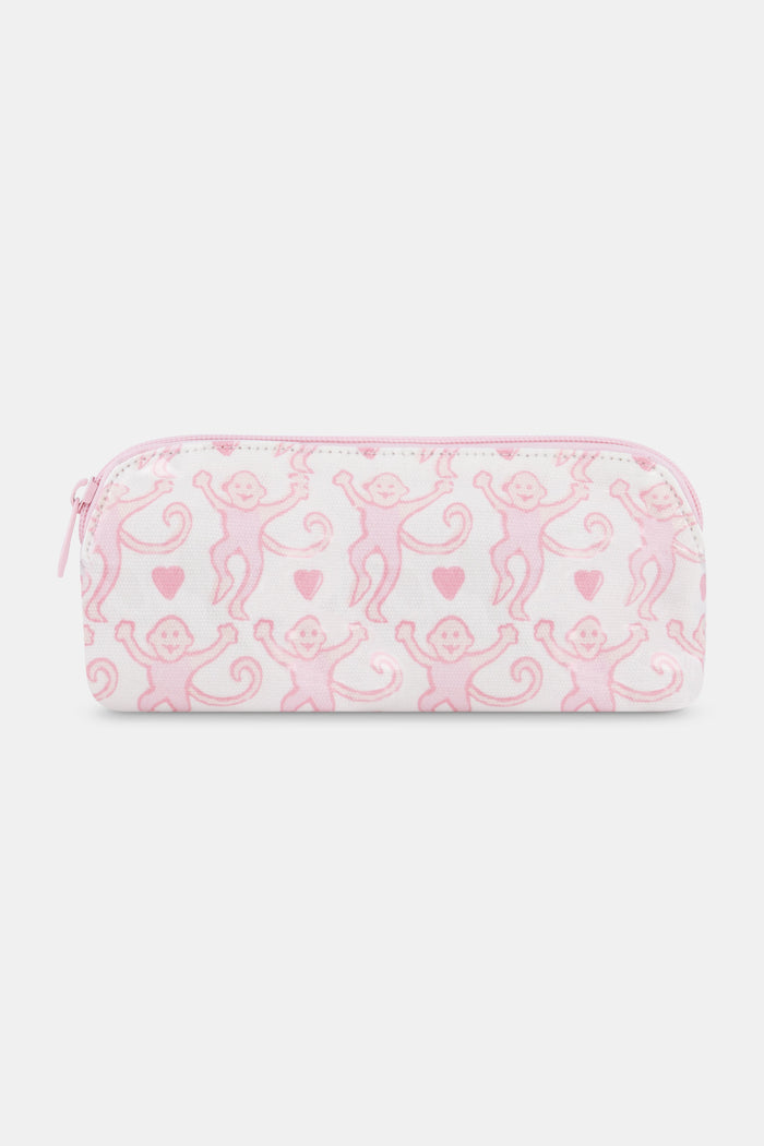 The Lovely Monkey Makeup Bag by Roller Rabbit is a rectangular white cotton canvas pouch with a pink zipper, featuring a repeating pattern of pink cartoon monkeys and small pink hearts.